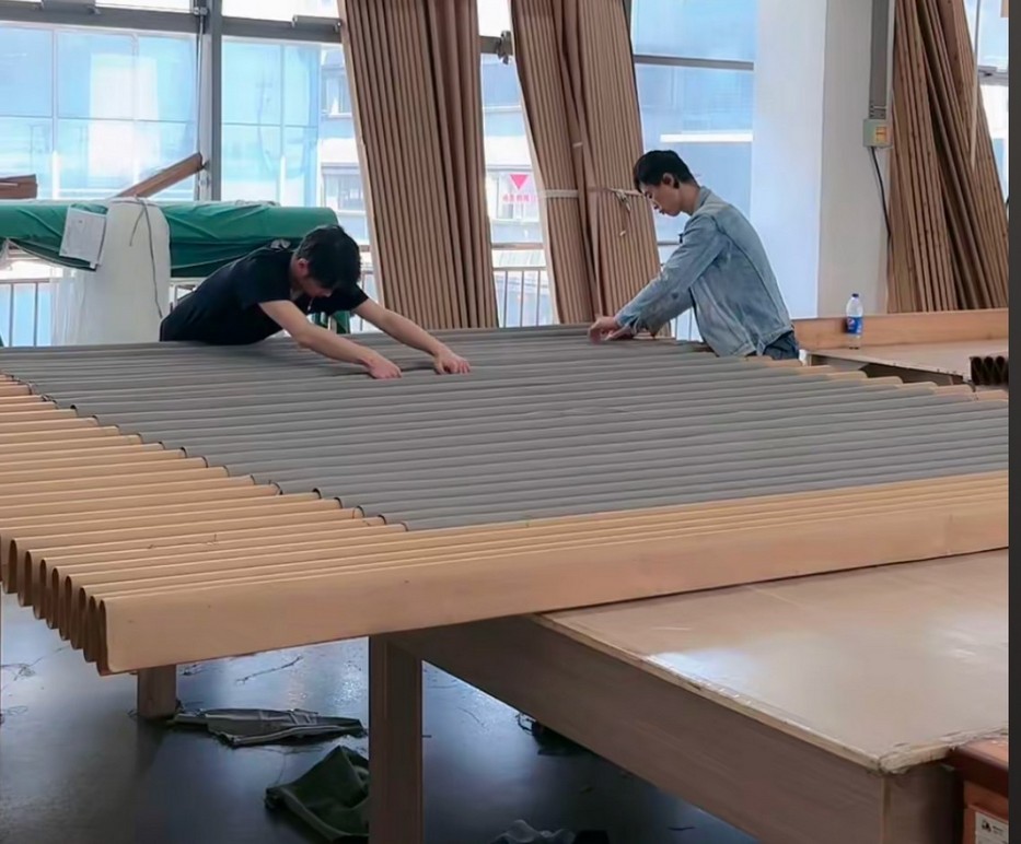 Two workers aligning curtains on a setting film.